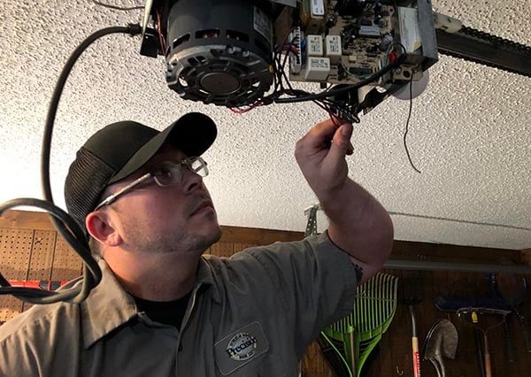 Technician Performing Garage Door Opener Repair Maintenance