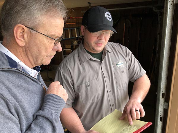 Customer and technician review what was found in 25-point inspection