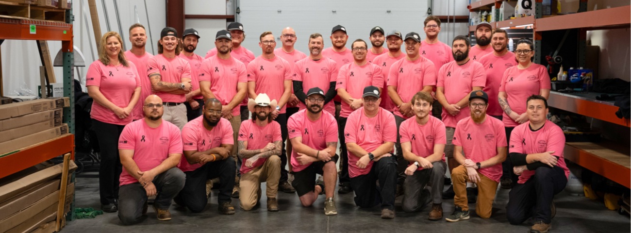 Precision team group photo in pink Breast Cancer Awareness shirts Precision team group photo in pink Breast Cancer Awareness shirts