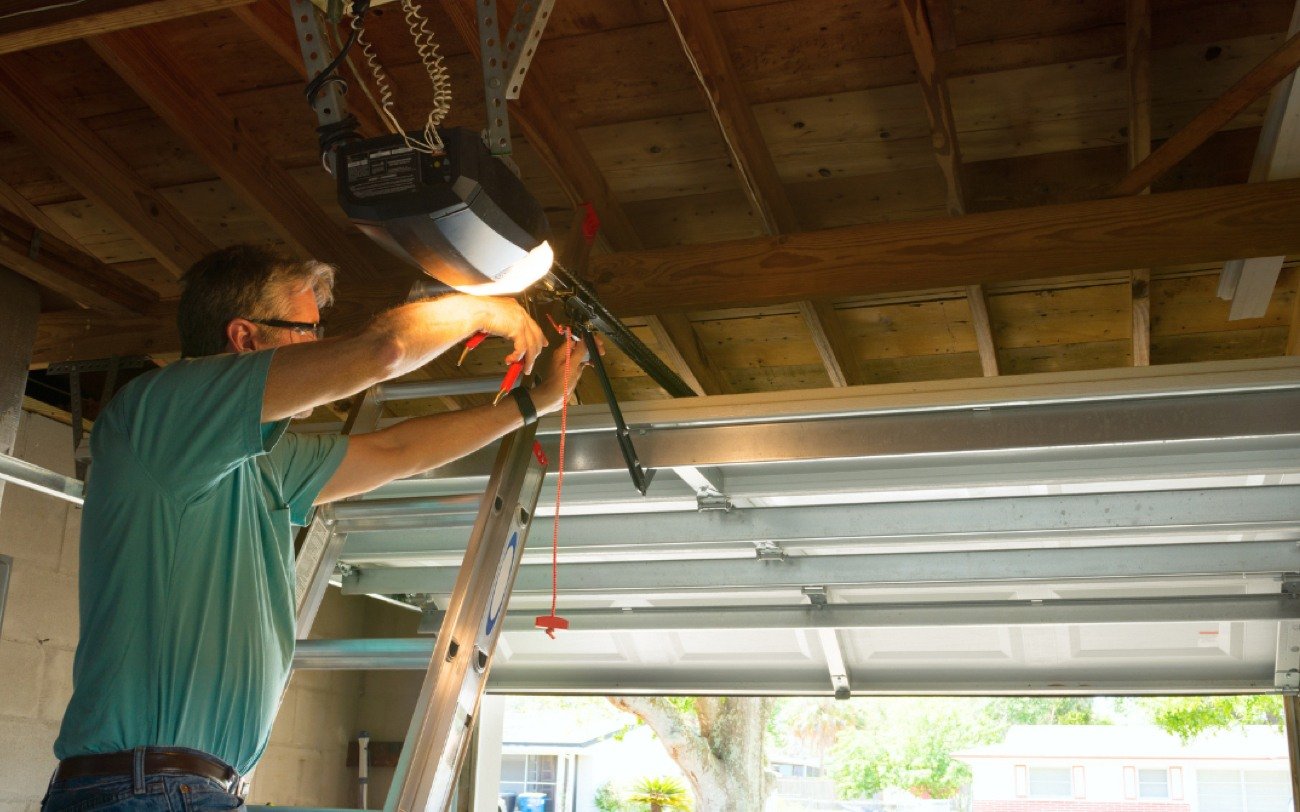 Precision Technician Repairing a New Garage Door Opener