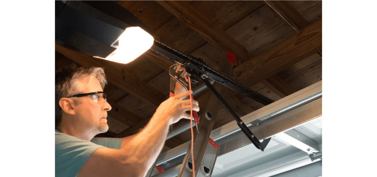 Man repairing garage door opener chain Man repairing garage door opener chain