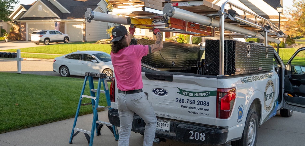 Precision technician unloading truck in Breast Cancer Awareness pink shirt Precision technician unloading truck in Breast Cancer Awareness pink shirt