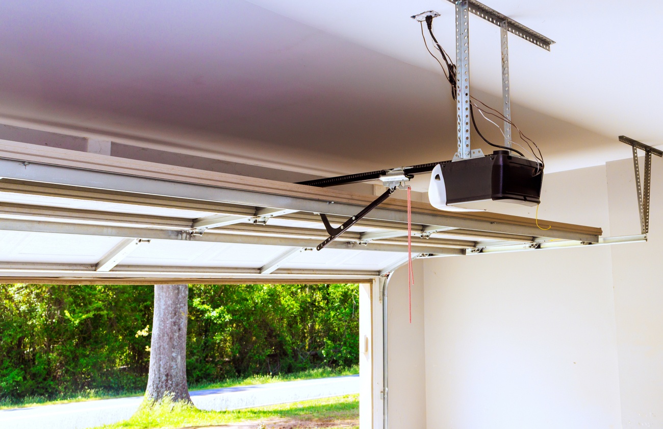 Open garage door with focus on interior garage door opener Open garage door with focus on interior garage door opener