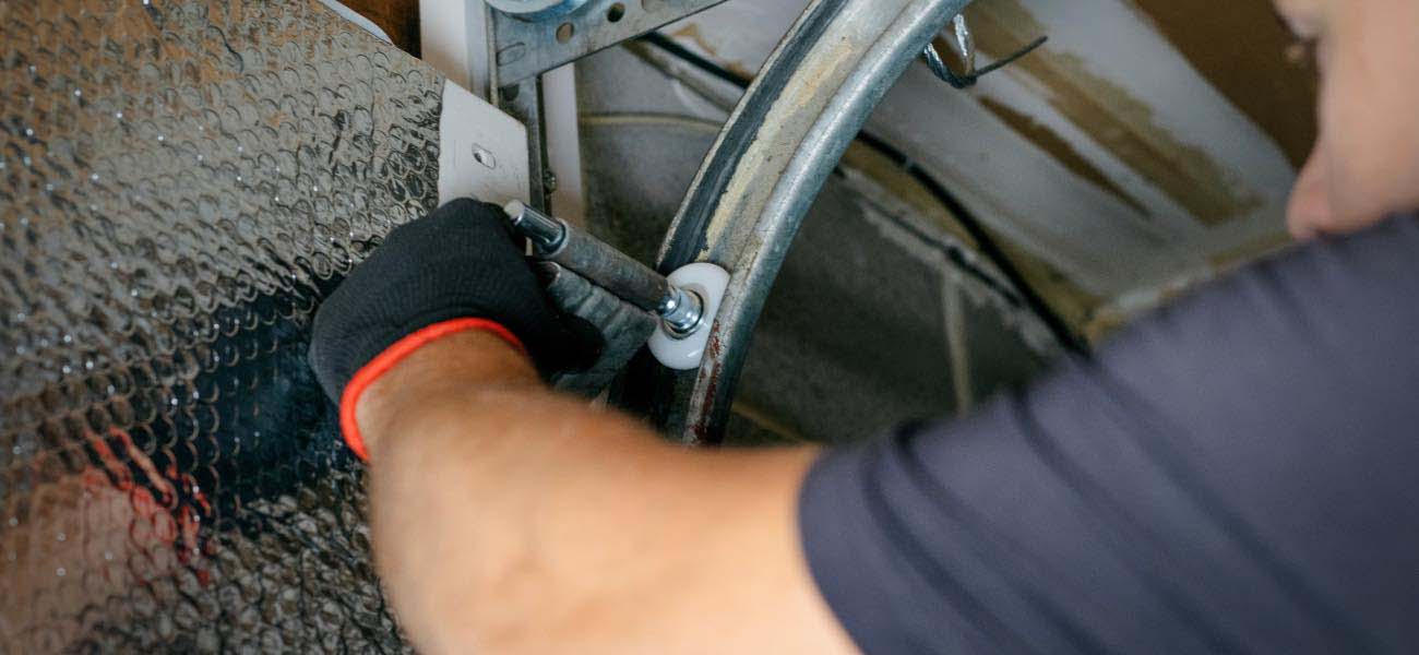 Precision Technician Performing Maintenance on Garage Door