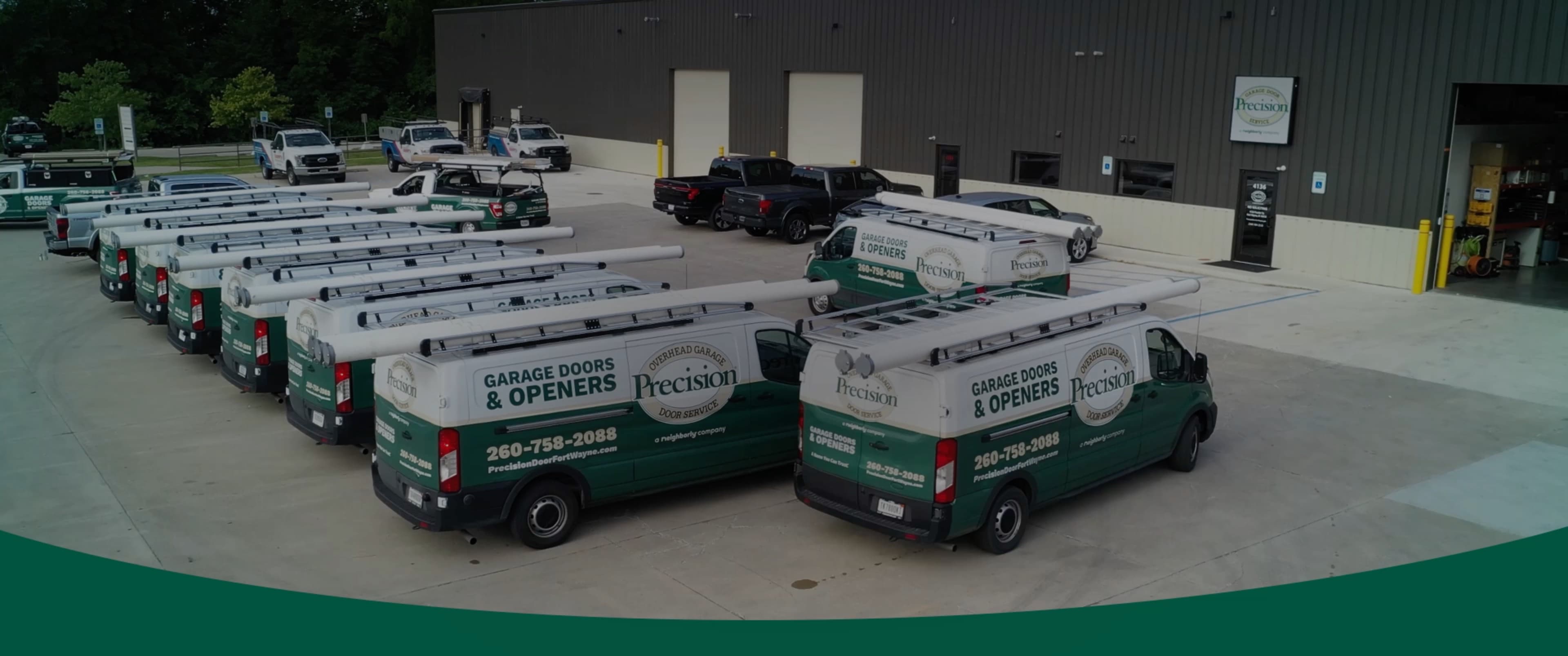 Precision Garage Door Service of Fort Wayne van parked at house with new garage door.