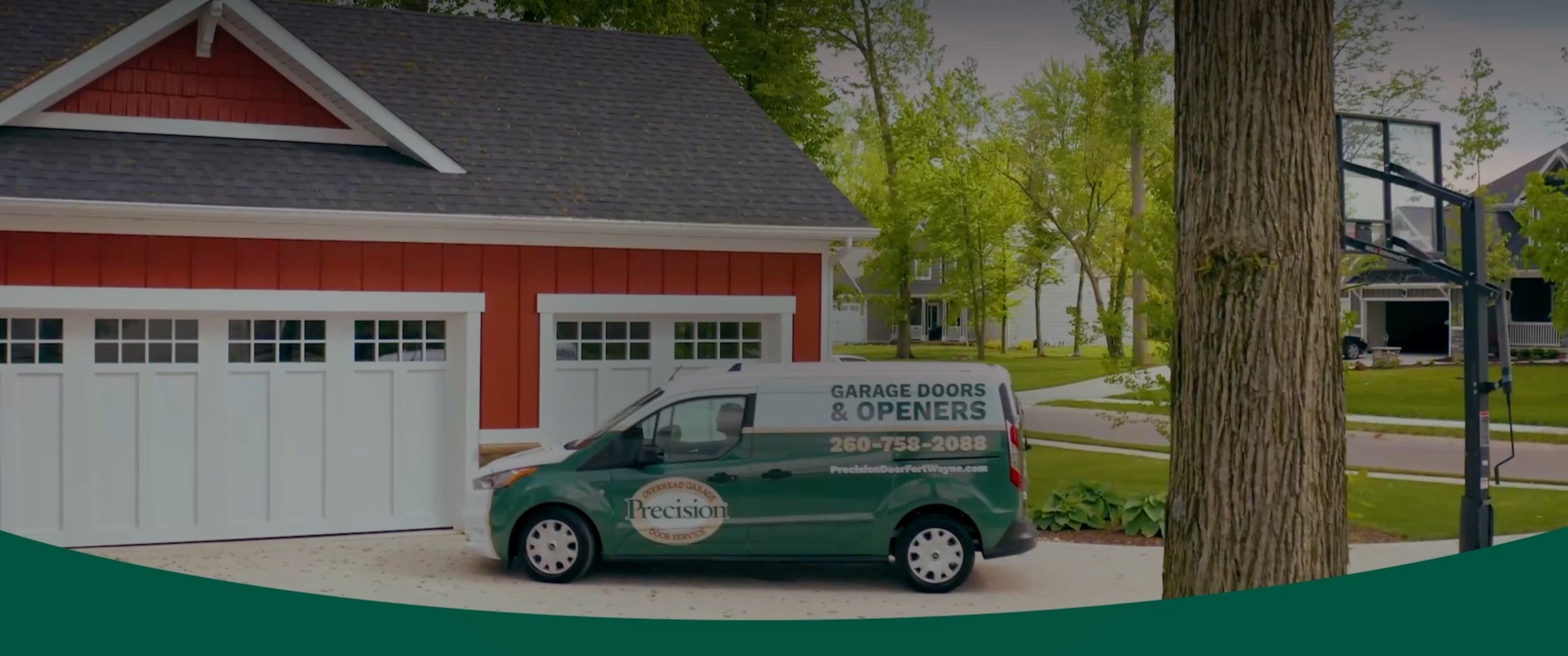 Precision Garage Door Service of Fort Wayne van parked at house with new garage door.