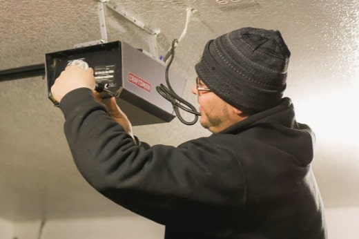 Precision Technician Performing Maintenance on a Garage Door Opener
