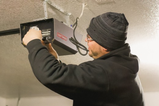 Precision Technician Working on a Garage Door Opener