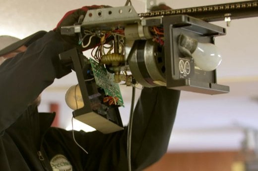 Precision Technician Repairing a Garage Door Opener