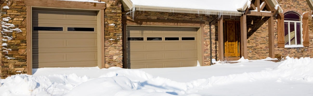 Double Garage Door House Covered in Snow